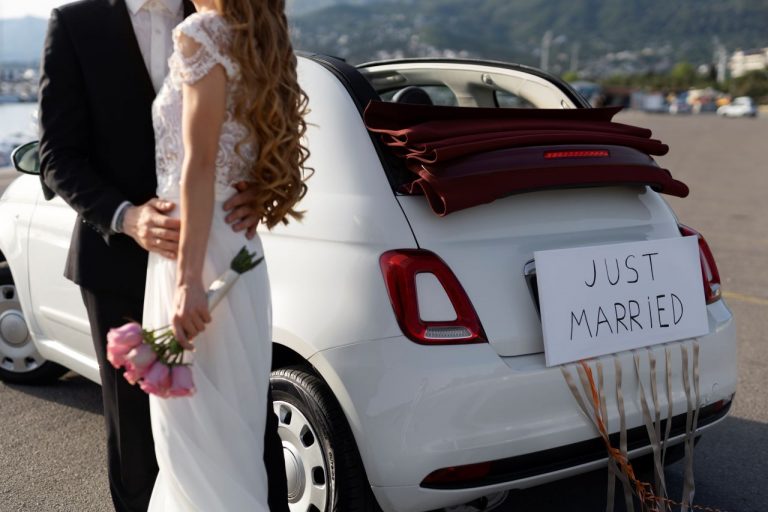 A happy cuple near a Wedding Taxi in Ashford